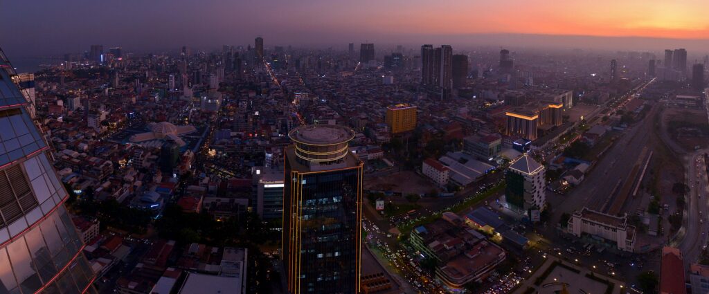 Stunning aerial view of Phnom Penh's cityscape at sunset, showcasing urban architecture.